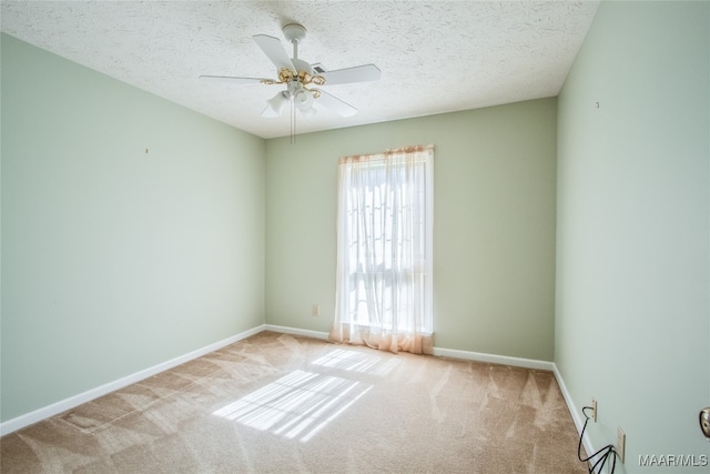 unfurnished room featuring light carpet, a textured ceiling, and ceiling fan