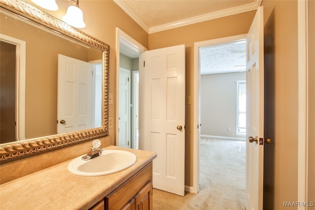 bathroom featuring vanity, crown molding, and a textured ceiling