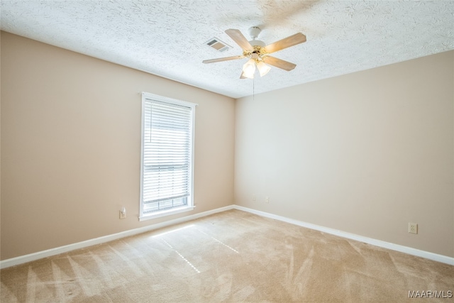 carpeted empty room featuring a textured ceiling and ceiling fan