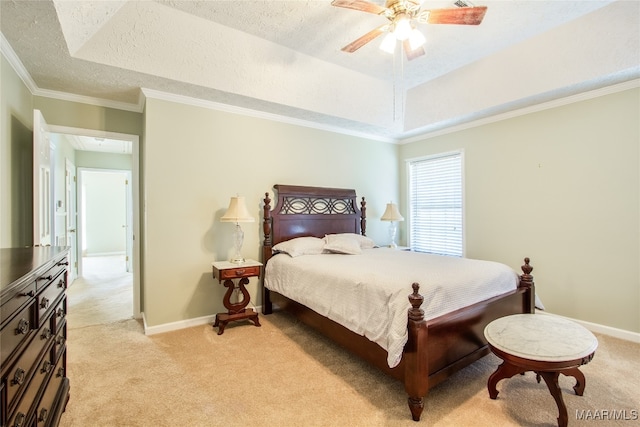 carpeted bedroom featuring ornamental molding, a textured ceiling, a raised ceiling, and ceiling fan