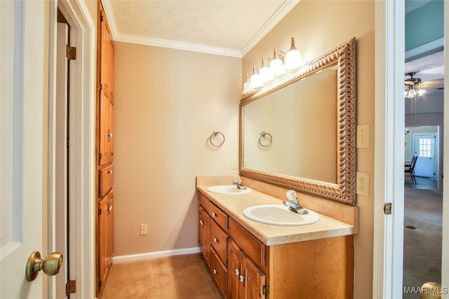 bathroom with vanity, ceiling fan, a textured ceiling, and ornamental molding