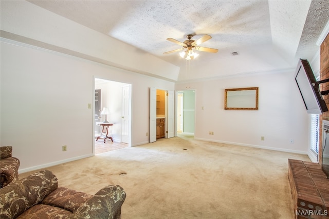 carpeted living room featuring a textured ceiling, a fireplace, and ceiling fan