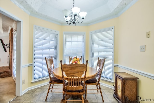 dining space with crown molding, a notable chandelier, and a textured ceiling