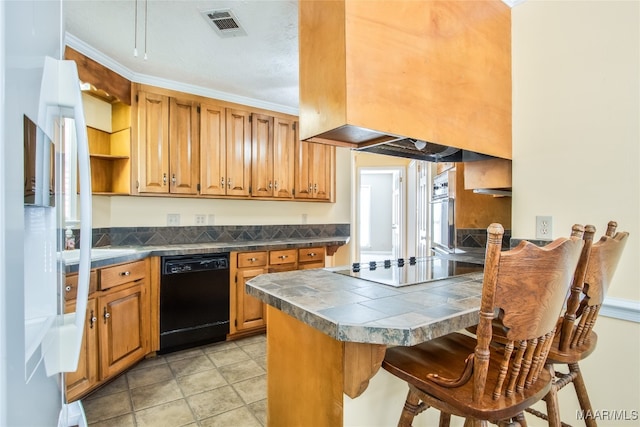 kitchen featuring kitchen peninsula, black dishwasher, tile countertops, a kitchen bar, and ornamental molding