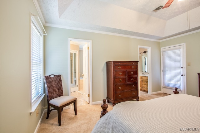 bedroom with ensuite bathroom, a textured ceiling, light carpet, ceiling fan, and ornamental molding