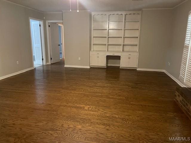 unfurnished living room with baseboards, ornamental molding, and dark wood finished floors