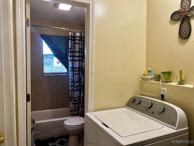 clothes washing area with a textured ceiling and washer / clothes dryer