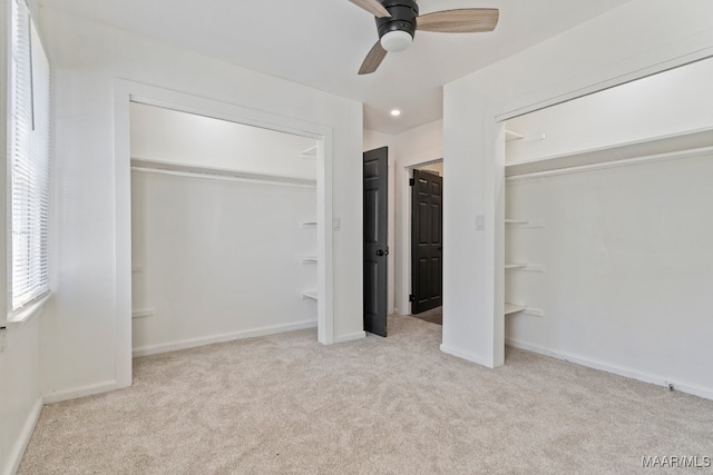 unfurnished bedroom featuring ceiling fan and light colored carpet