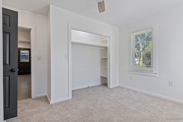 unfurnished bedroom with a closet, ceiling fan, and light carpet