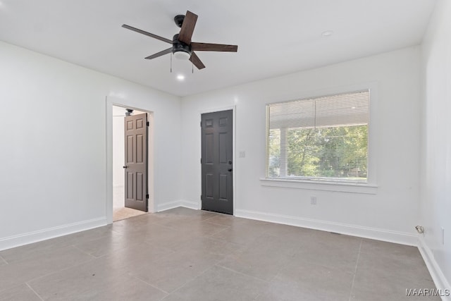 unfurnished room featuring light tile patterned floors and ceiling fan