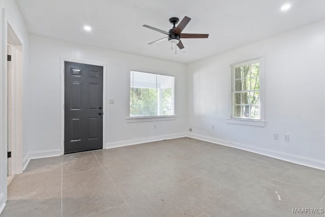 tiled entryway with plenty of natural light and ceiling fan