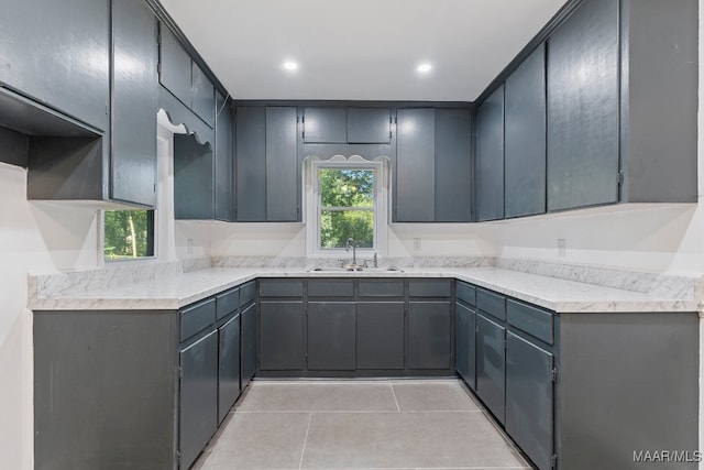 kitchen with light tile patterned flooring, sink, and gray cabinets