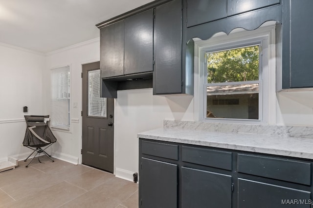 kitchen with ornamental molding and light tile patterned flooring