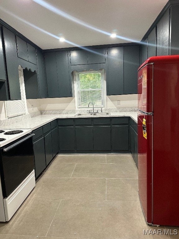 kitchen with white range with electric stovetop, sink, light tile patterned floors, and refrigerator