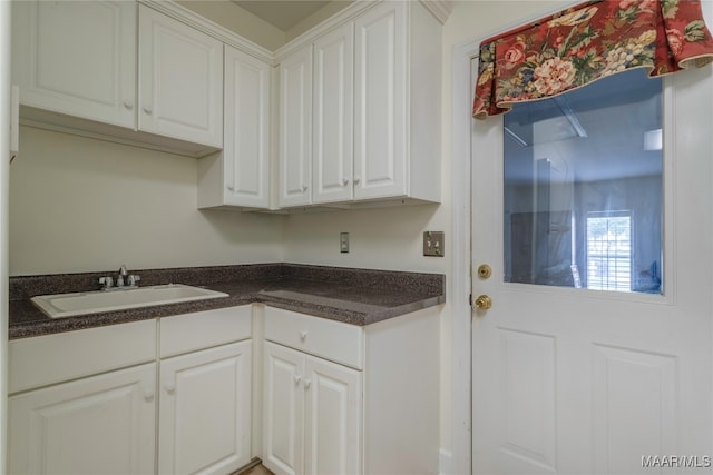 kitchen with white cabinetry and sink