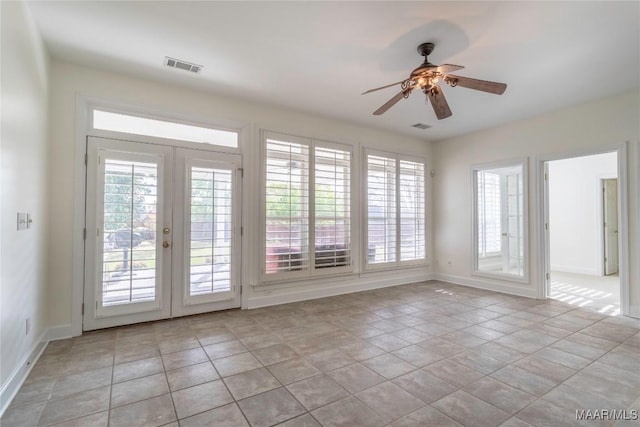 entryway featuring french doors, ceiling fan, light tile patterned flooring, and a wealth of natural light