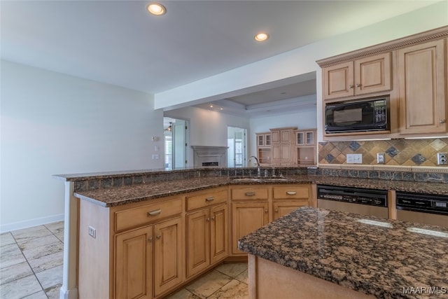 kitchen with light brown cabinetry, tasteful backsplash, black microwave, sink, and stainless steel dishwasher