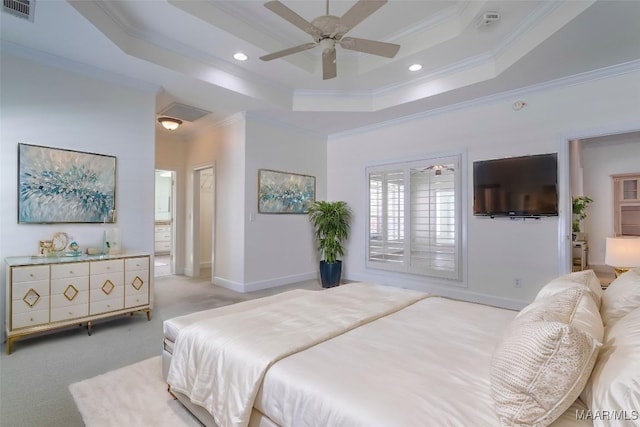 carpeted bedroom featuring connected bathroom, ornamental molding, a raised ceiling, and ceiling fan