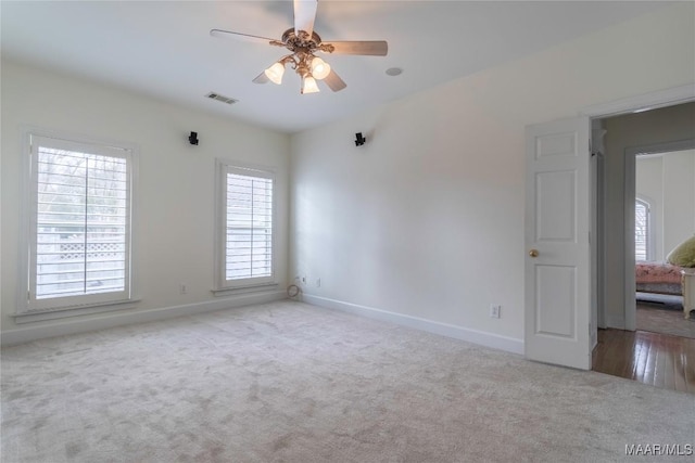 carpeted empty room featuring ceiling fan