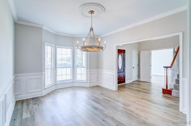 200 Mcrae Rd, Deatsville, AL 36022 - unfurnished dining area with a chandelier, stairs, light wood-type flooring, wainscoting, and a decorative wall