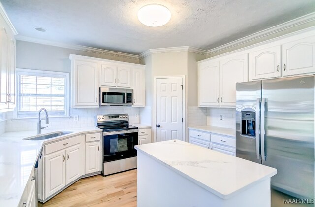 kitchen featuring stainless steel appliances, sink, and white cabinets