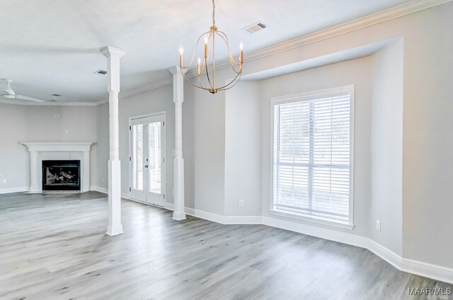 unfurnished living room with crown molding, hardwood / wood-style flooring, and a tile fireplace