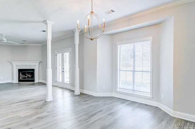 200 Mcrae Rd, Deatsville, AL 36022 - unfurnished living room featuring wood finished floors, healthy amount of natural light, a chandelier, ornamental molding, and baseboards