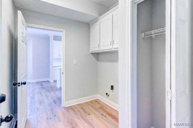 clothes washing area with light wood-type flooring