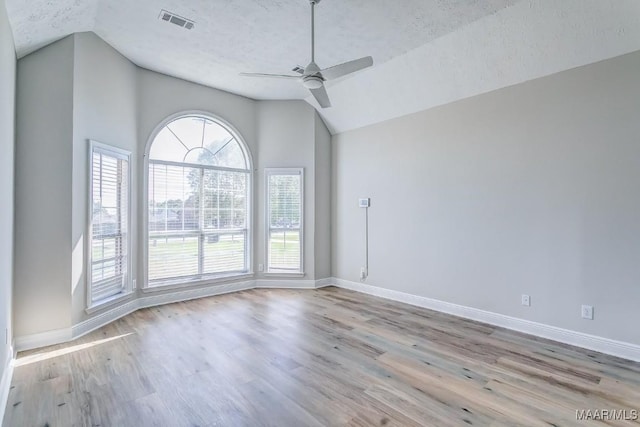 200 Mcrae Rd, Deatsville, AL 36022 - unfurnished room featuring vaulted ceiling, a ceiling fan, a textured ceiling, plenty of natural light, and baseboards