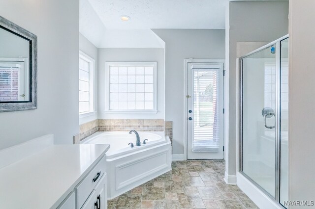 bathroom featuring vanity and shower with separate bathtub