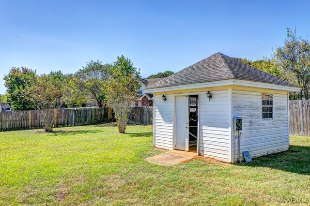 view of outbuilding with a yard