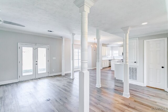 entryway with french doors, crown molding, light wood-type flooring, and ceiling fan