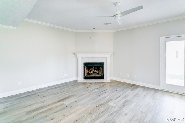 unfurnished living room featuring ornamental molding, light hardwood / wood-style floors, and ceiling fan