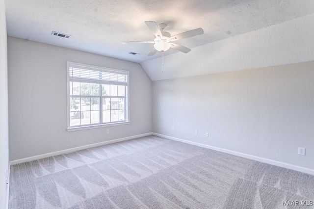 200 Mcrae Rd, Deatsville, AL 36022 - empty room with baseboards, light carpet, a ceiling fan, lofted ceiling, and a textured ceiling