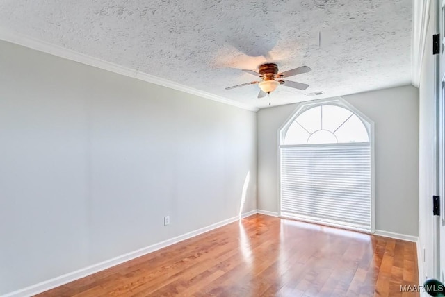 200 Mcrae Rd, Deatsville, AL 36022 - spare room with ceiling fan, wood finished floors, a textured ceiling, baseboards, and ornamental molding