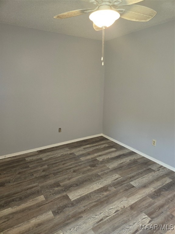 empty room with ceiling fan, a textured ceiling, and dark hardwood / wood-style flooring