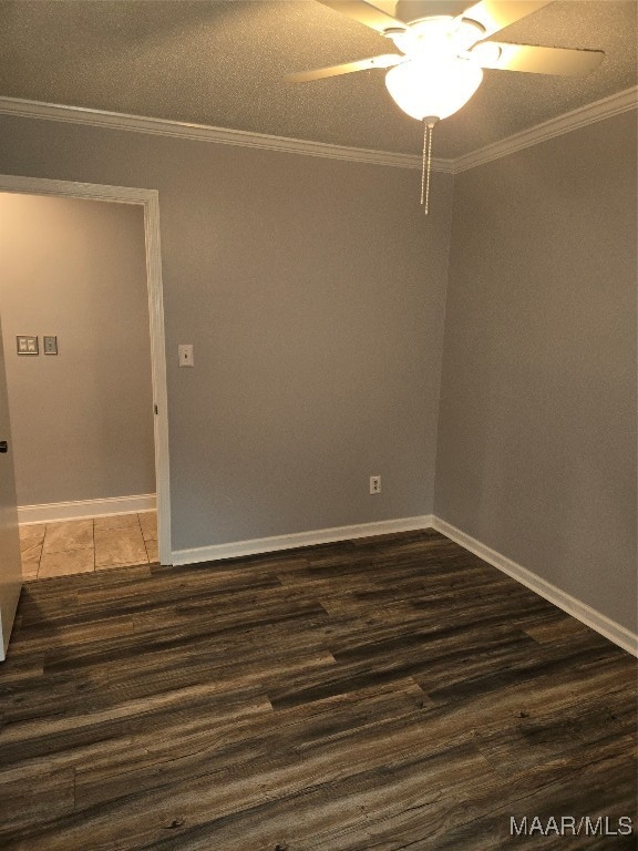 empty room featuring ornamental molding, dark wood-type flooring, a textured ceiling, and ceiling fan