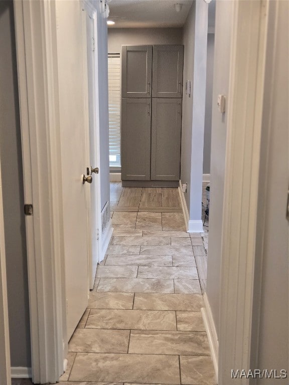 hallway with light hardwood / wood-style flooring