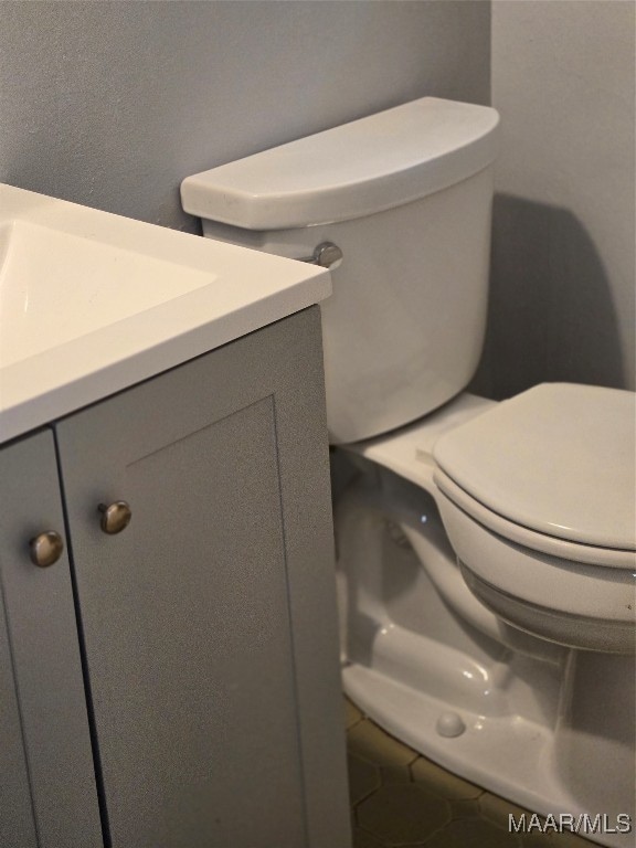 bathroom featuring vanity, toilet, and tile patterned floors