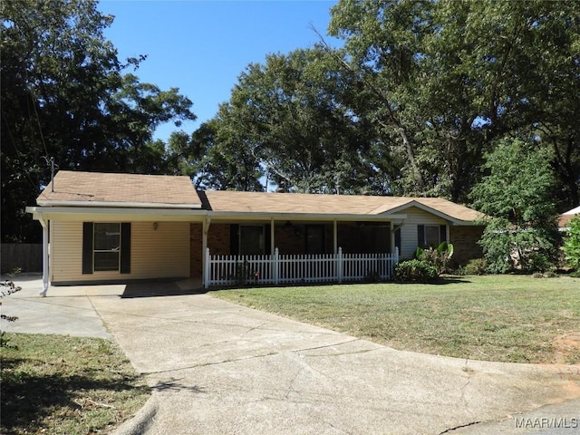 ranch-style house featuring a carport and a front lawn