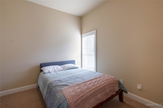 carpeted bedroom featuring lofted ceiling