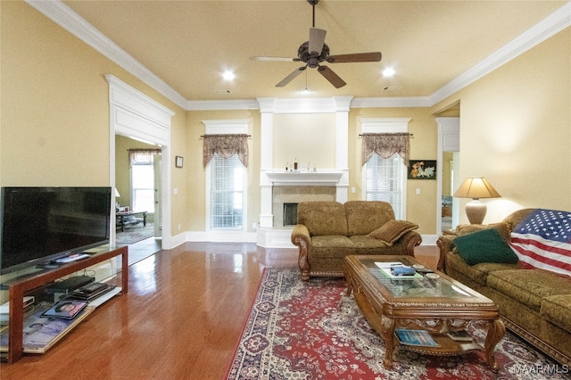 living room featuring crown molding, hardwood / wood-style flooring, and ceiling fan