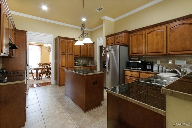 kitchen with appliances with stainless steel finishes, sink, a kitchen island, hanging light fixtures, and ornamental molding