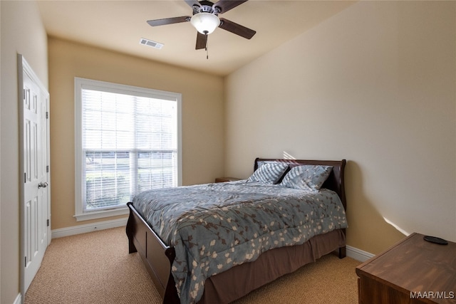 bedroom with light colored carpet and ceiling fan