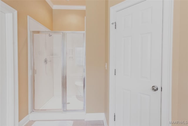 bathroom featuring an enclosed shower and tile patterned flooring