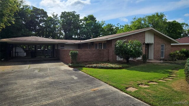 ranch-style home featuring a front yard and a carport