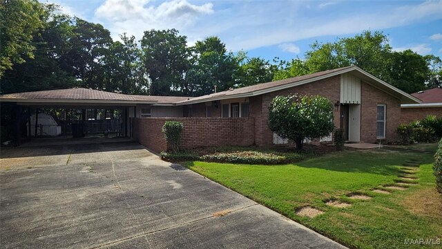 ranch-style home with a front yard and a carport