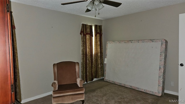 unfurnished room featuring dark colored carpet, a textured ceiling, and ceiling fan