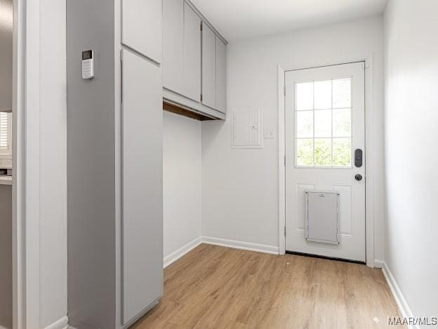 entryway featuring light wood-type flooring and baseboards