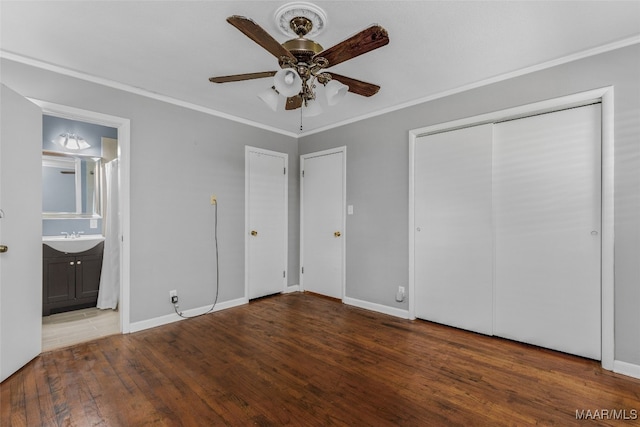 unfurnished bedroom featuring sink, dark hardwood / wood-style flooring, ceiling fan, connected bathroom, and ornamental molding